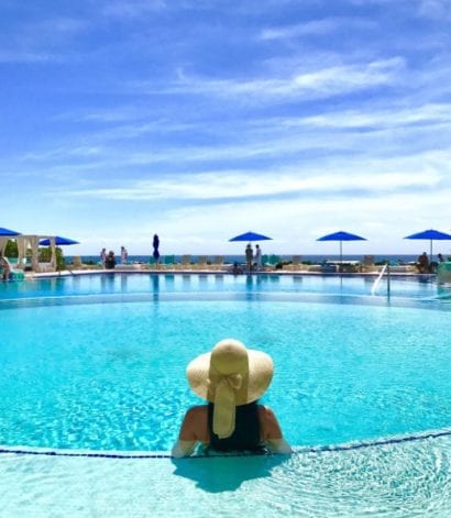 woman relaxing at swim up bar at a Caribbean resort